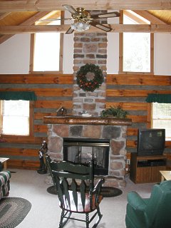 The Great Room and cozy fireplace of the Chickasaw Log Cabin